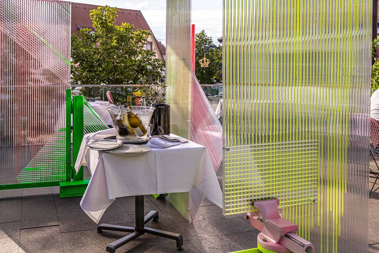 Kunst in Zeiten von Corona. Der Künstler Samuel Treindl entwarf einen Spuckschutz. Schutz und Zierde zugleich für die Terrasse im Restaurant Krone / © Foto: Georg Berg